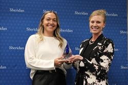 Representative from KPMG accepting the 2023 Co-op and Internship Employer of the Year Award from Sheridan