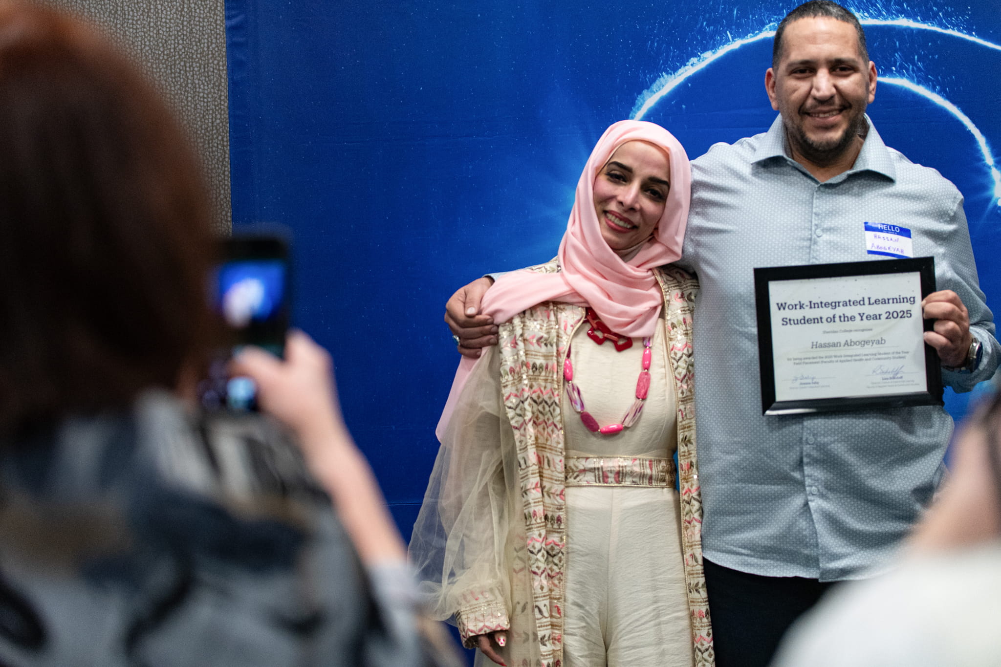 A 2025 Sheridan Co-op and Work-Integrated Learning Student of the Year Award recipient poses for a photo with a loved one