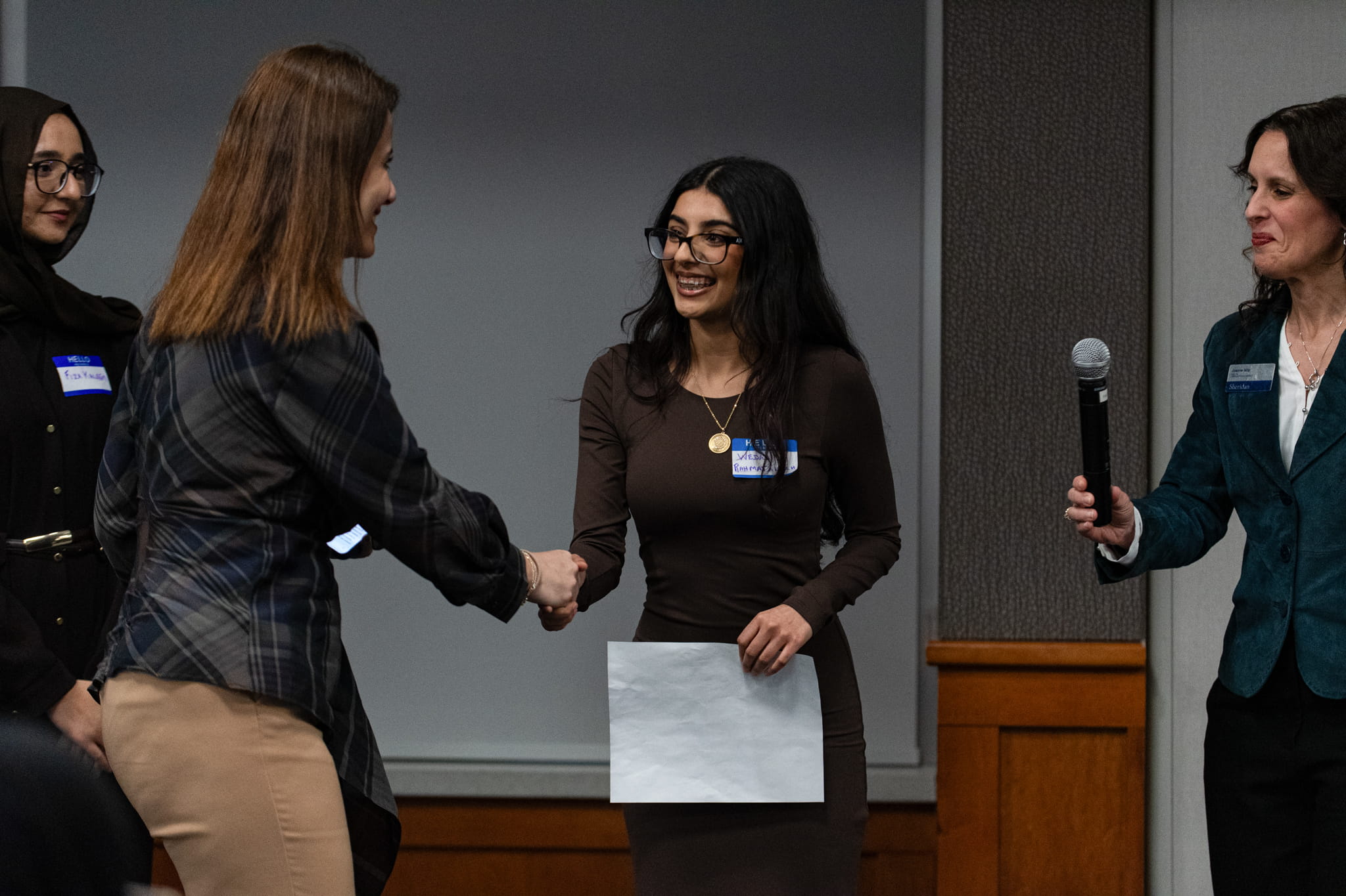 Dean of Sheridan's Pilon School of Business (PSB), Shahrzad Farzinpak stops to shake hands with the PSB Student of the Year Award recipients