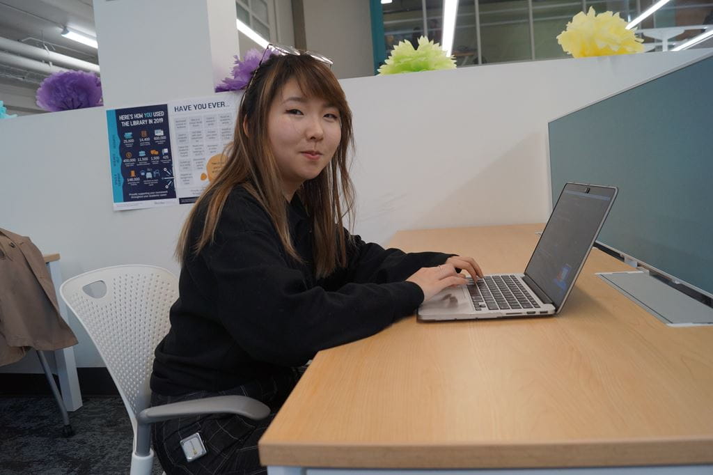 Christina Weng typing on a laptopp