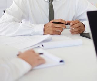 People at table with papers and pens