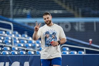 Athletic Therapy student David Loiacono is pictured on the field of the Rogers Centre wearing shorts and a Kevin Gausman giveaway t-shirt