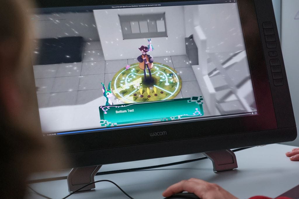 A computer screen with an animated character surrounded by a circular patch of grass on top of a black and white building