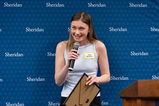 Emily McAllister smiles during a speech