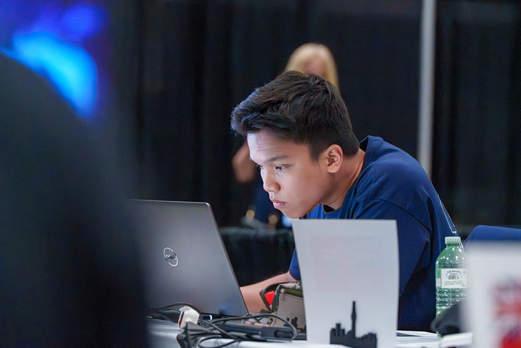 Thinh Luu working at a laptop during the Architectural Technology and Design event at Skills Canada