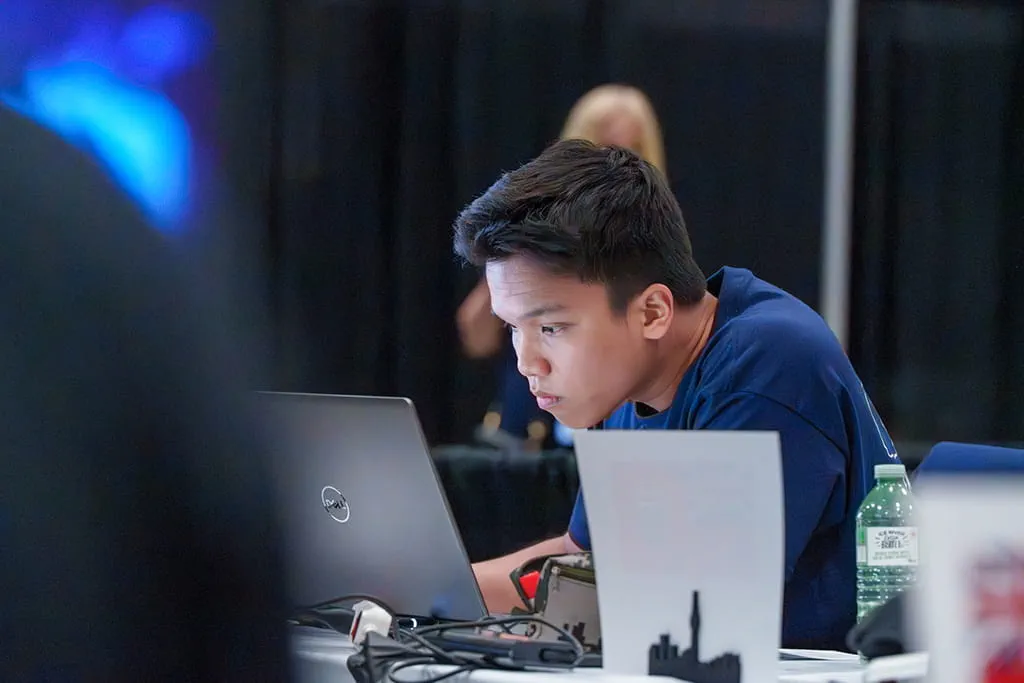 Thinh Luu working at a laptop during the Architectural Technology and Design event at Skills Canada