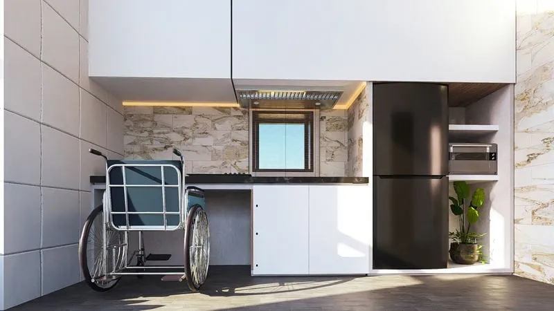 A rendering of a tiny home design in which a wheelchair fits underneath the countertop of a small kitchen space