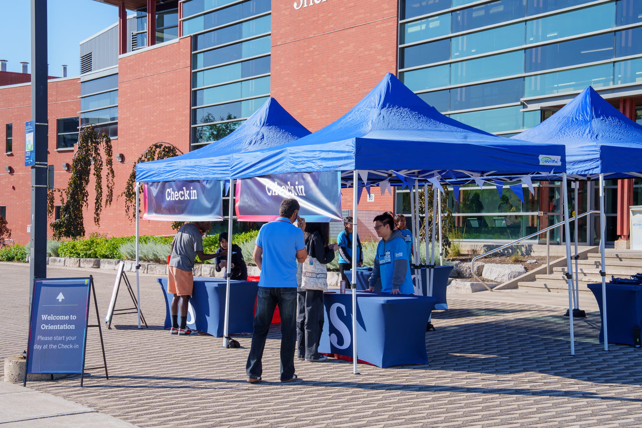 Student volunteers assist new students check into Sheridan's New Student Orientation