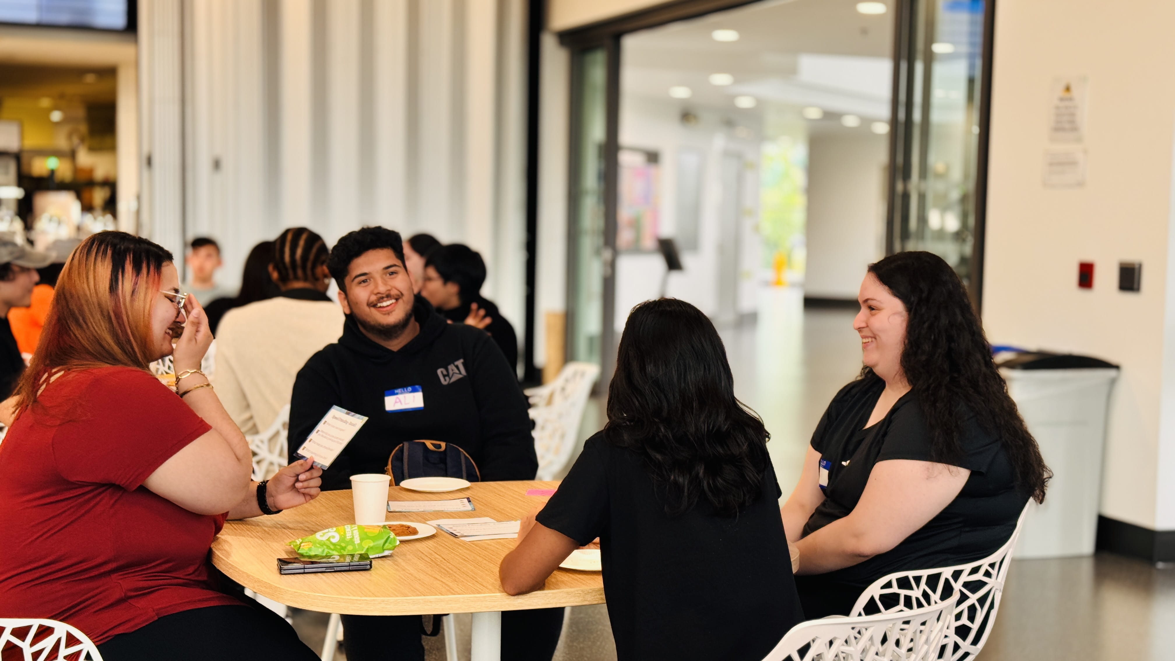 A group of students sit together at a table during Sheridan's HeadStart Days event at the Davis Campus in Brampton