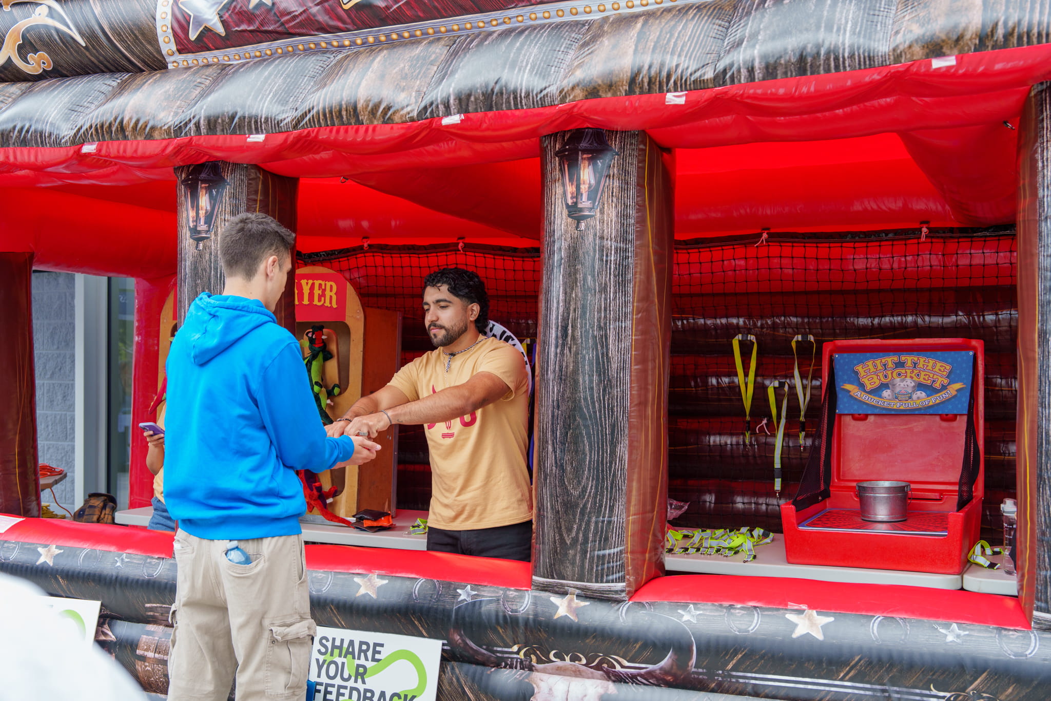 A student plays carnival game outside of the Sheridan Student Union's (SSU) student centre