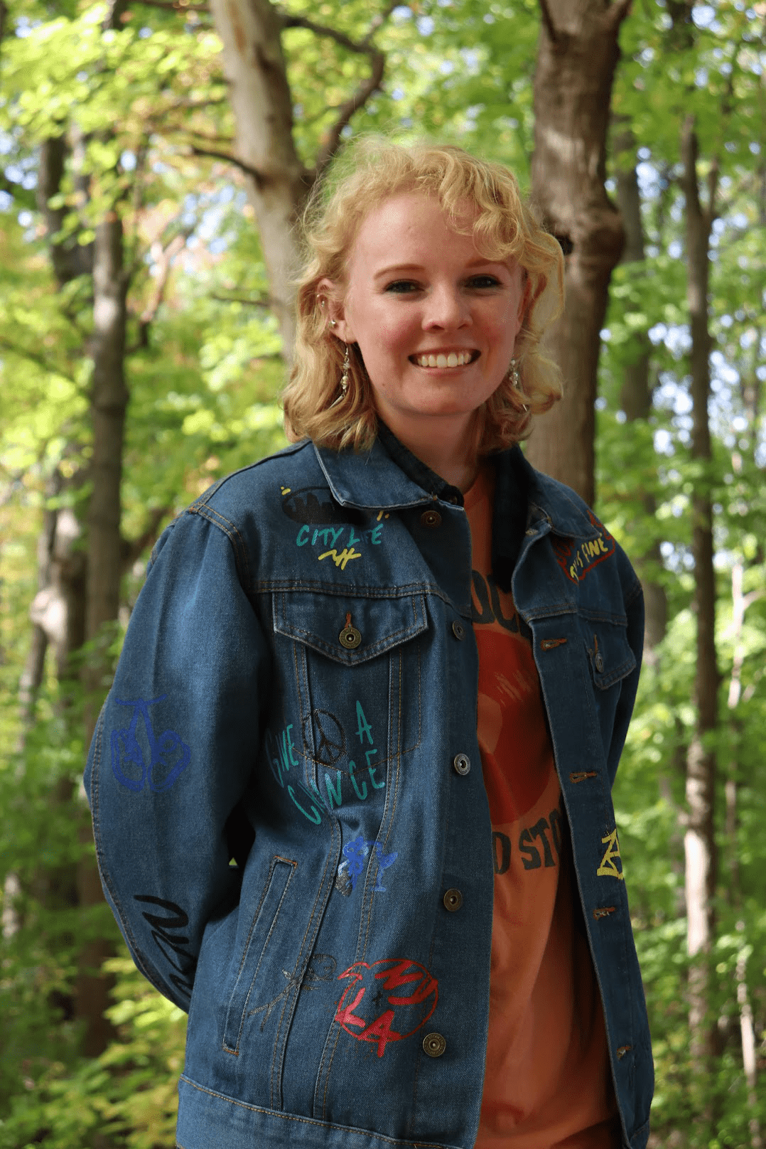 A photo of Kathryn Quirk standing in a forest
