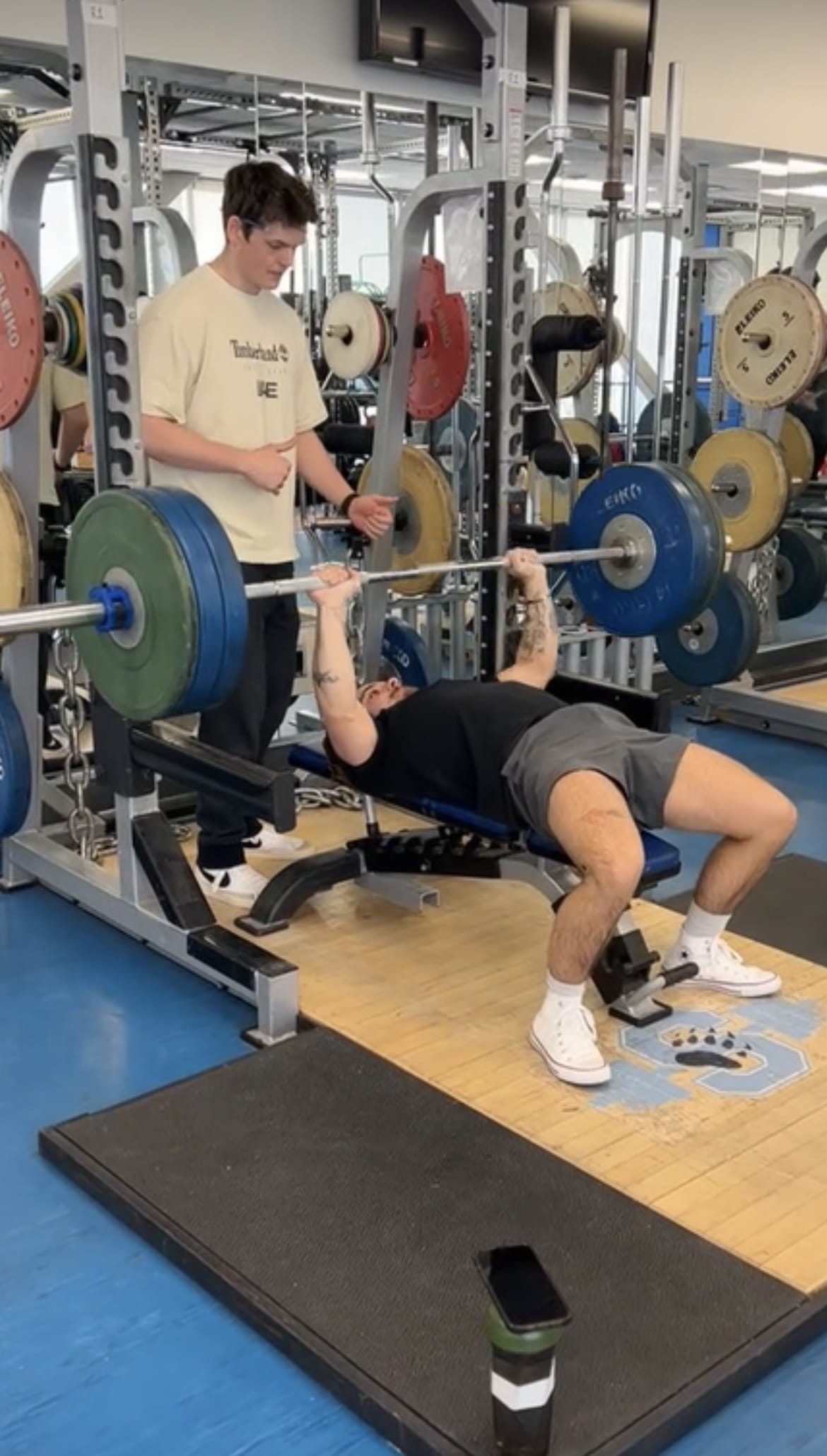 A photo of Jesse Plews lifting a benchpress in the Sheridan gym