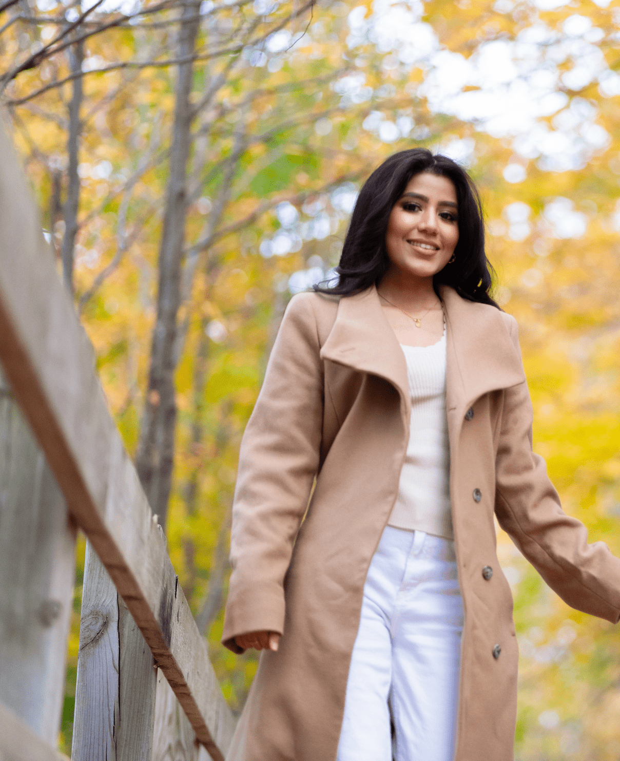 Mehreen Musharafa stands on a wooden bridge in a forested area