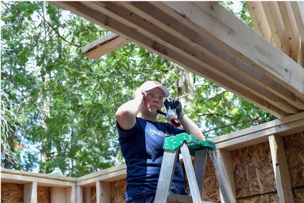 Kelsey Annan, Sheridan's Manager, Women in Red Seal Skilled Trades, FAST, prepares to work on some roof trusses.