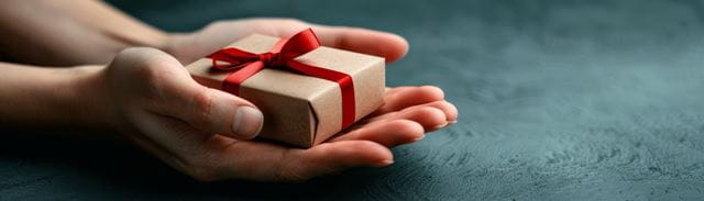 Outreached hands holding a small gift
