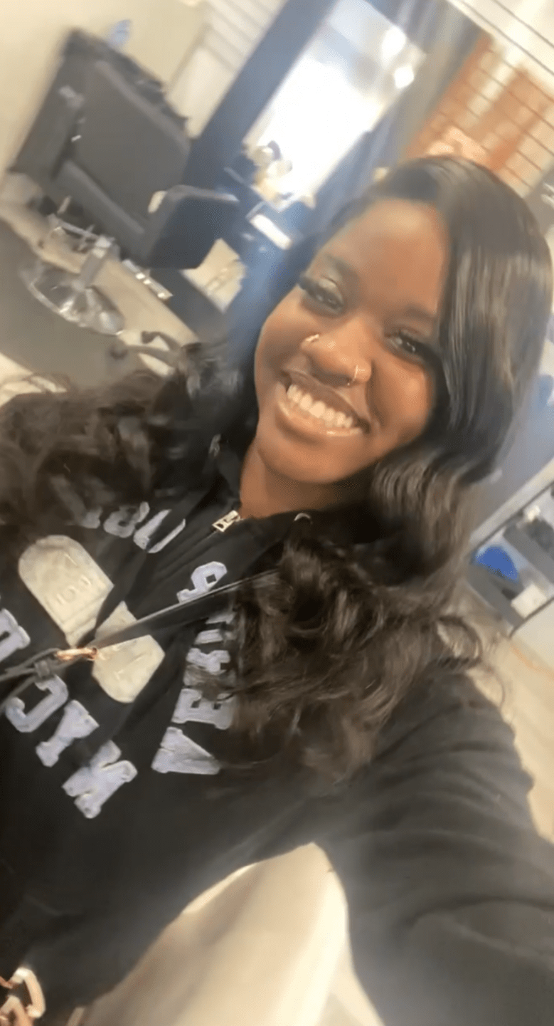 Valedictorian Ashantee Jones-Okere wears a black hoodie while taking a selfie.