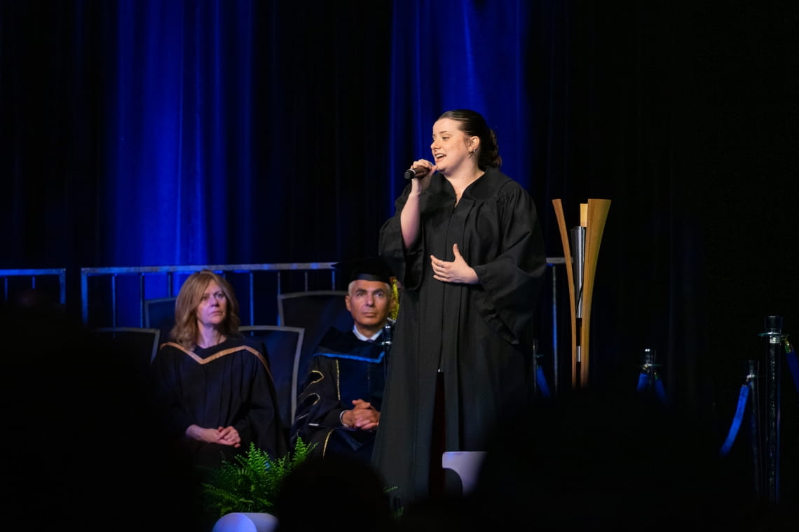 Singer Avery Rood performs a song on stage at convocation.