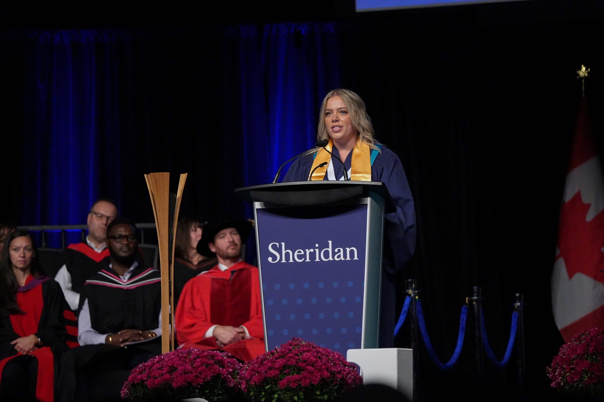 Brigida Campusano delivers her valedictorian speech on stage