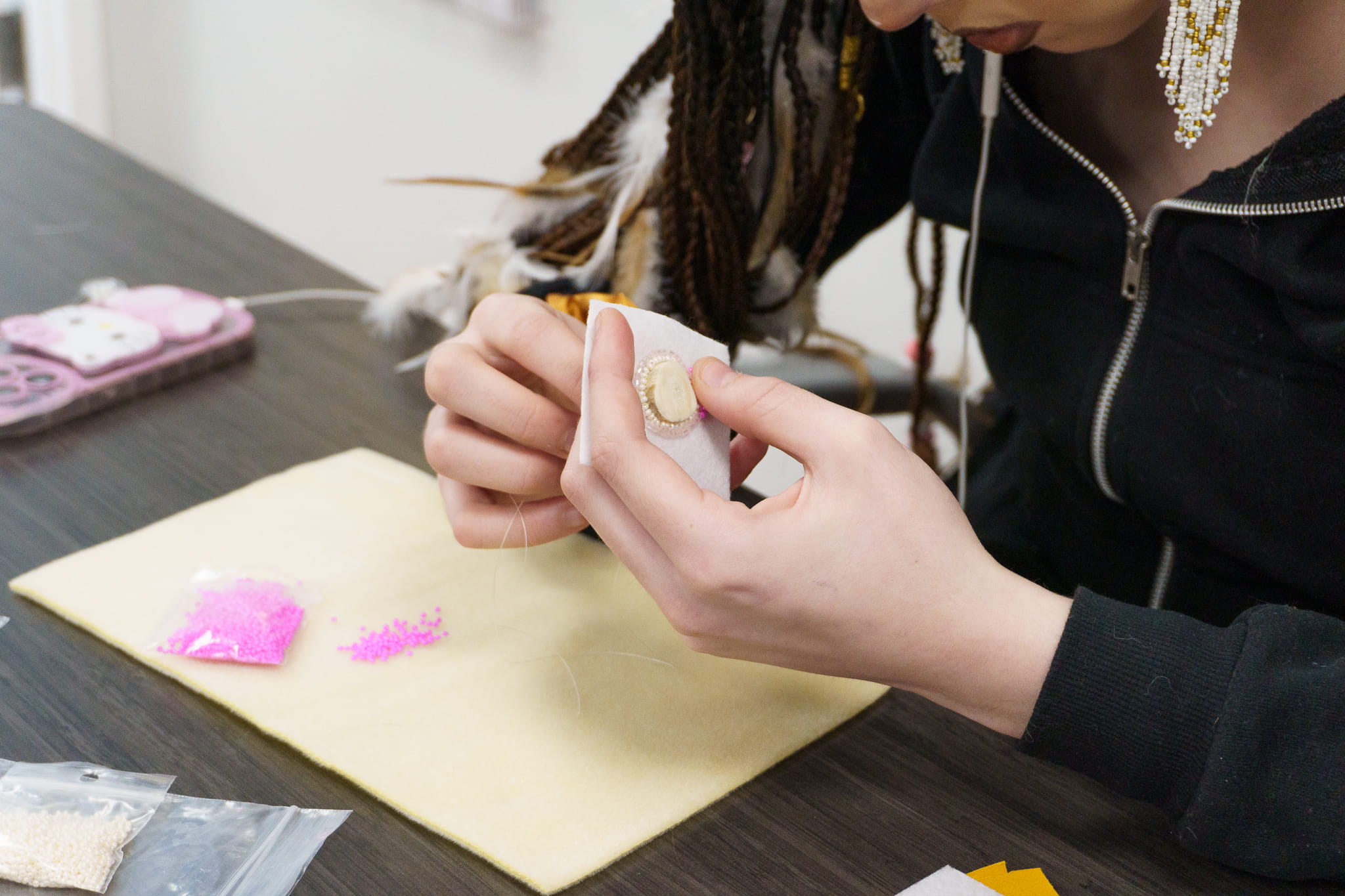 An Indigenous learner beading 