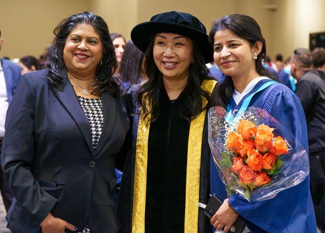 Dr. Cindy Gouveia poses with a mother and daughter at convocation.