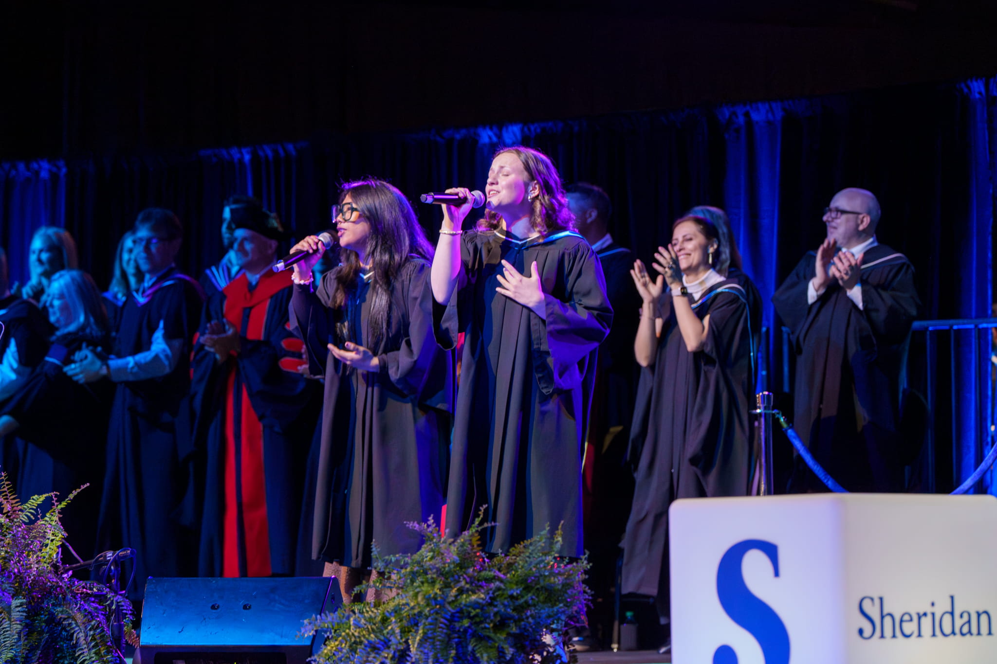Music performers Angelica Gicale and Frankie McKay sing a song on the convocation stage.