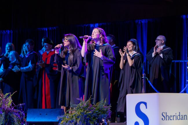 Music performers Angelica Gicale and Frankie McKay sing a song on the convocation stage.