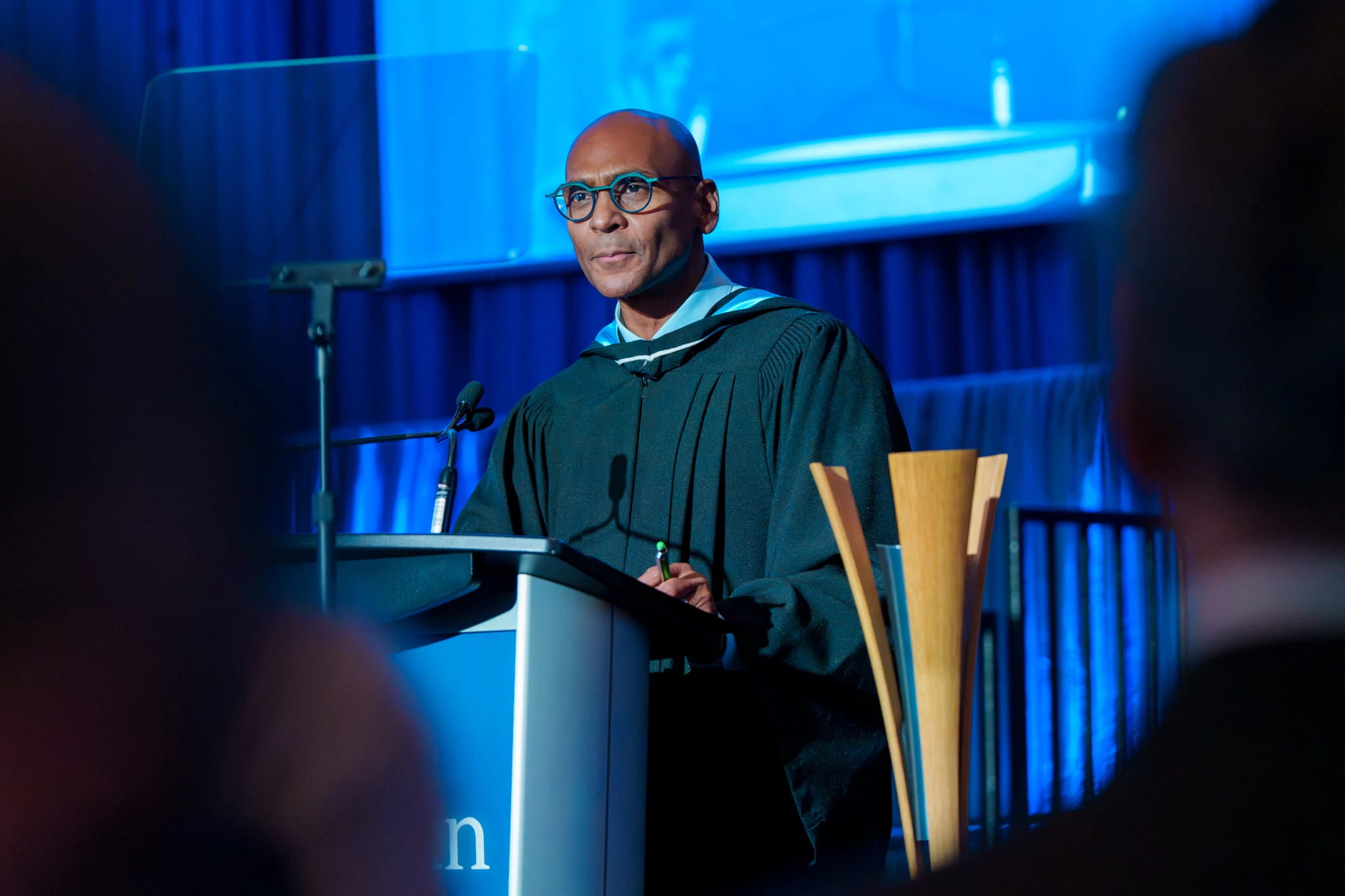 Al Ramsay stands and speaks at a podium.