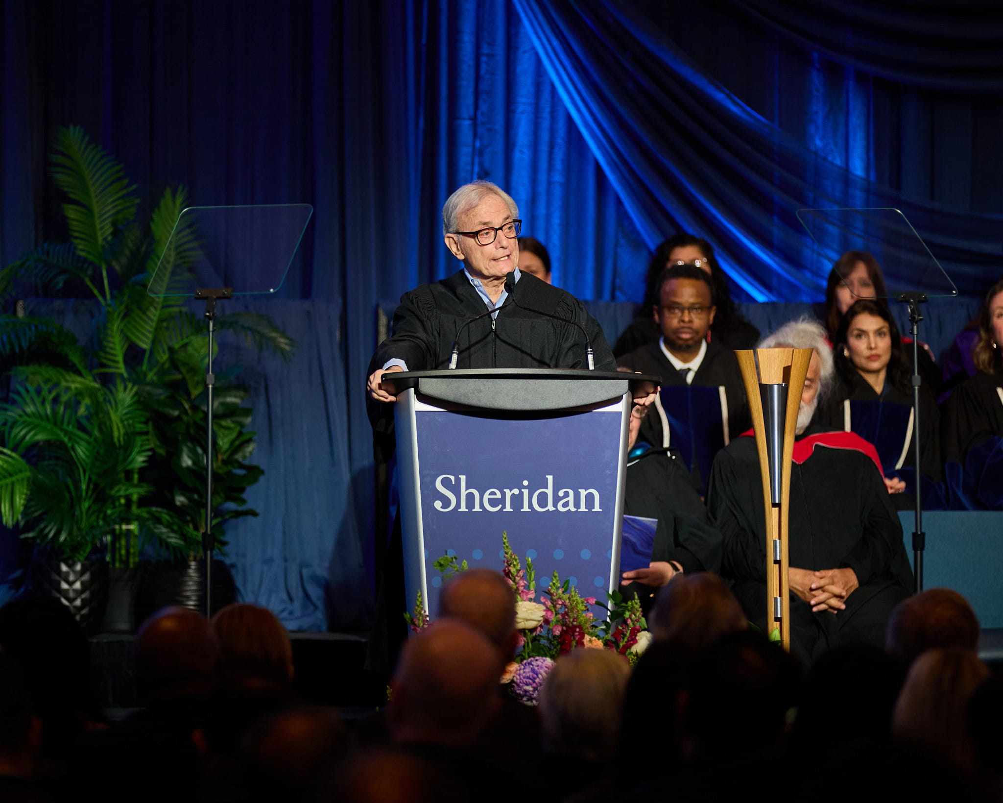 Honourable Marvin Zuker delivers his remarks at the podium.