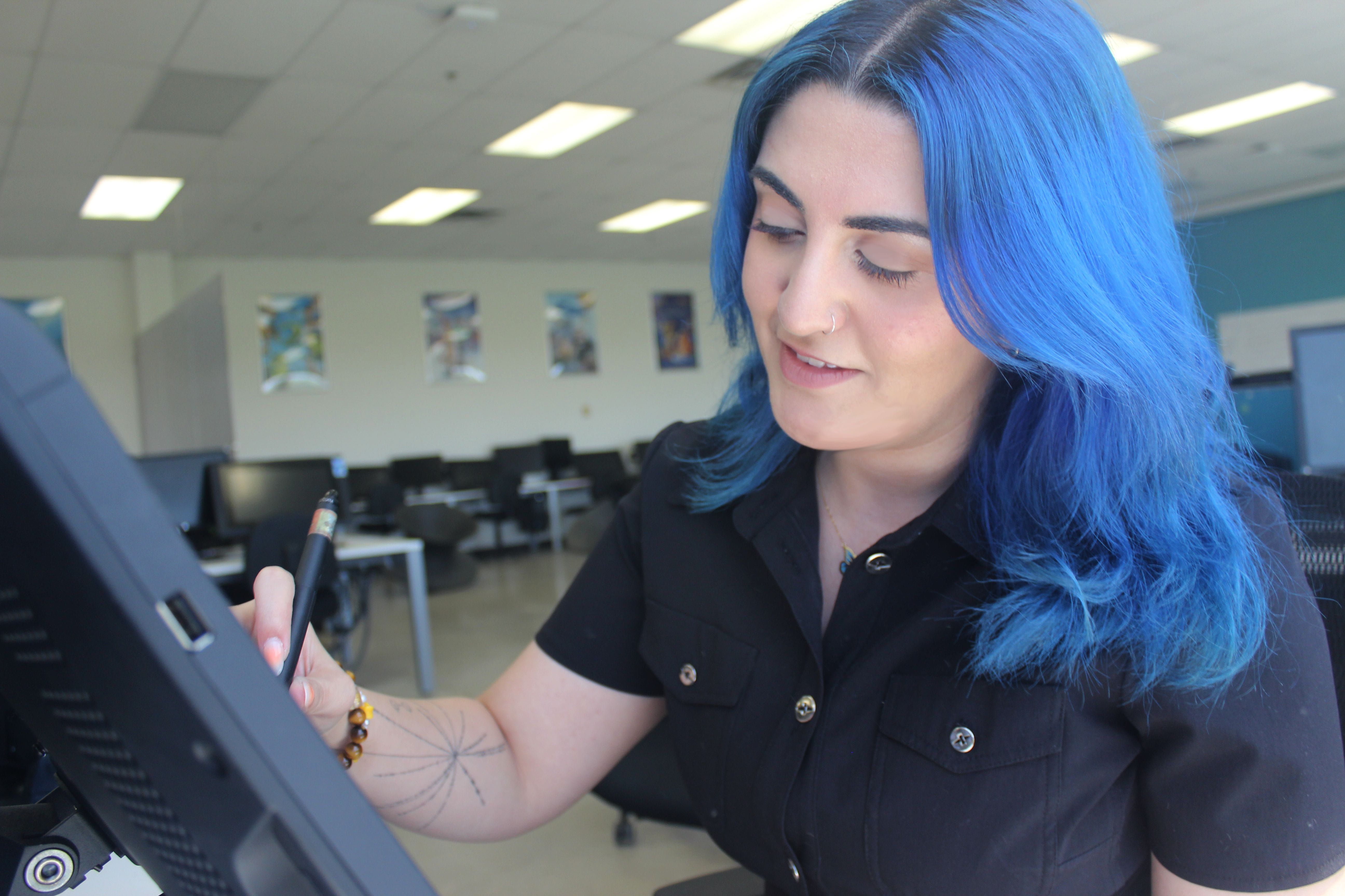 Valedictorian Roya Hmood works on an animation drawing.