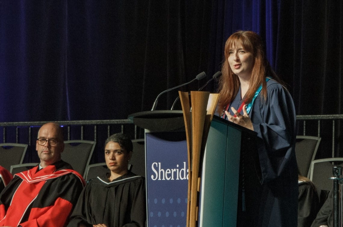 FAST valedictorian Tara Tyler shares her speech on stage at convocation