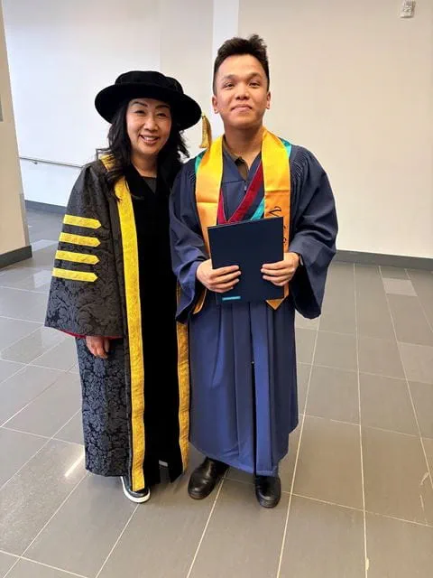 President Cindy Gouveia stands beside valedictorian Thinh Luu.