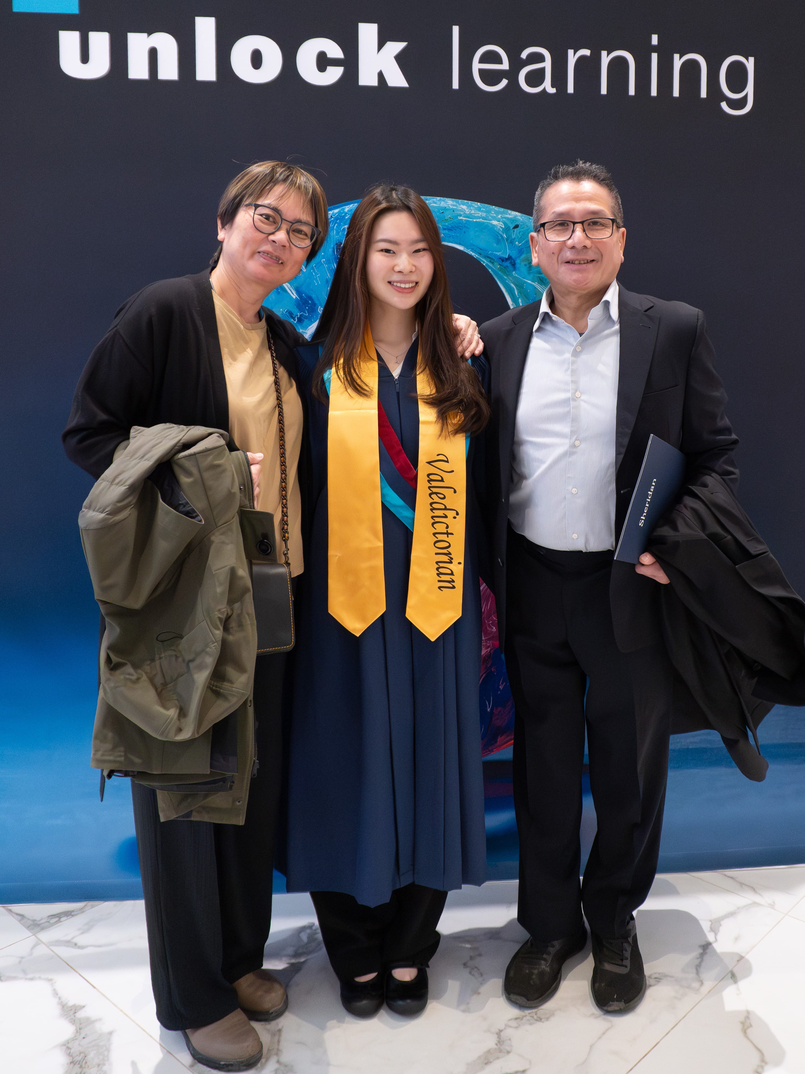 Valedictorian Aika Tsoi with her parents.