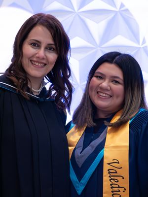 Dean Shahrzad Farzinpak stands beside valedictorian Geneva Garcia.