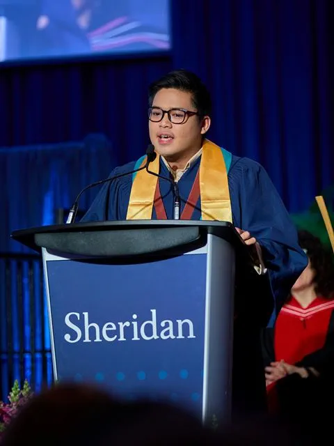 Valedictorian Nathan Sasing gives his speech at a podium.