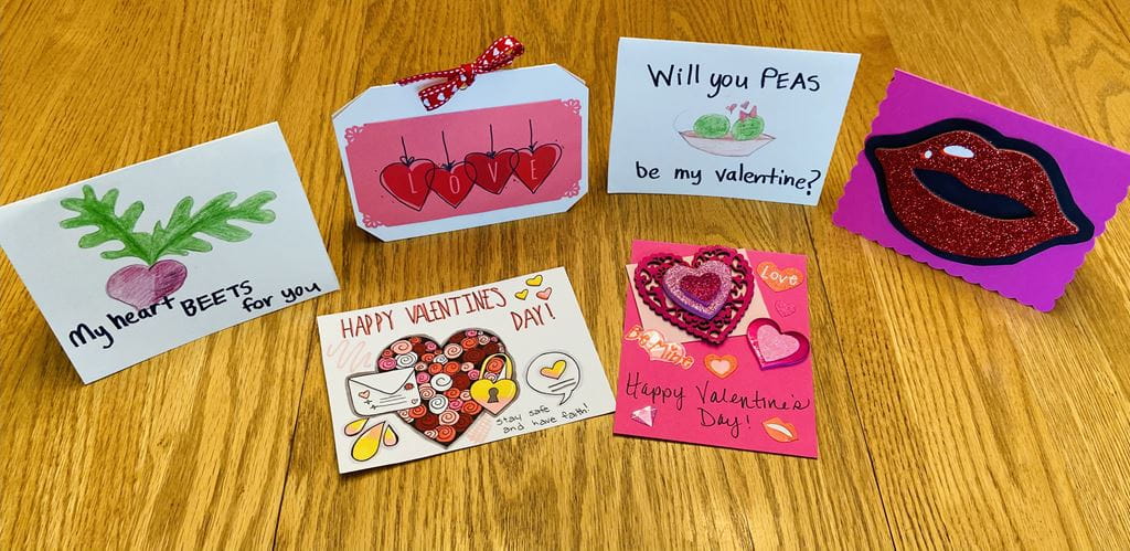 Hand-made Valentine's Day cards open on a table