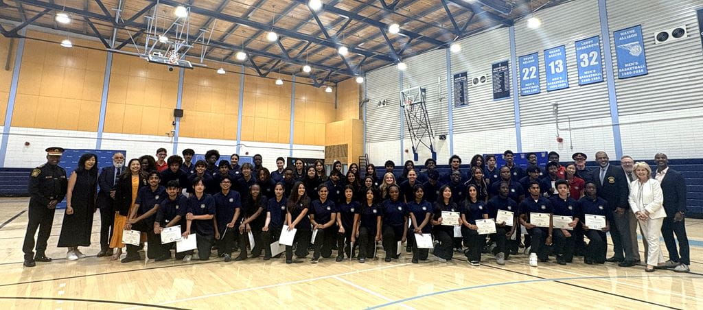 YIPI participants, Peel Police members, Sheridan staff and dignitaries pose for a photo in the gym.