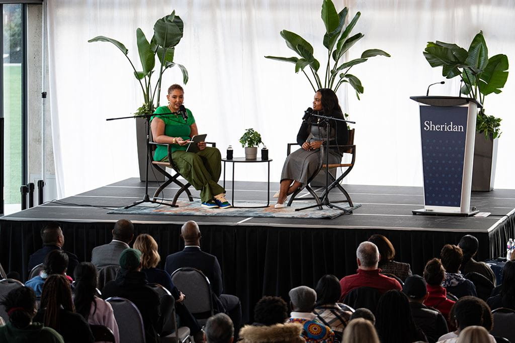 Kayla Grey and Alicia "Ace" West on stage at Sheridan's Hazel McCallion Campus for Black History Month 2024