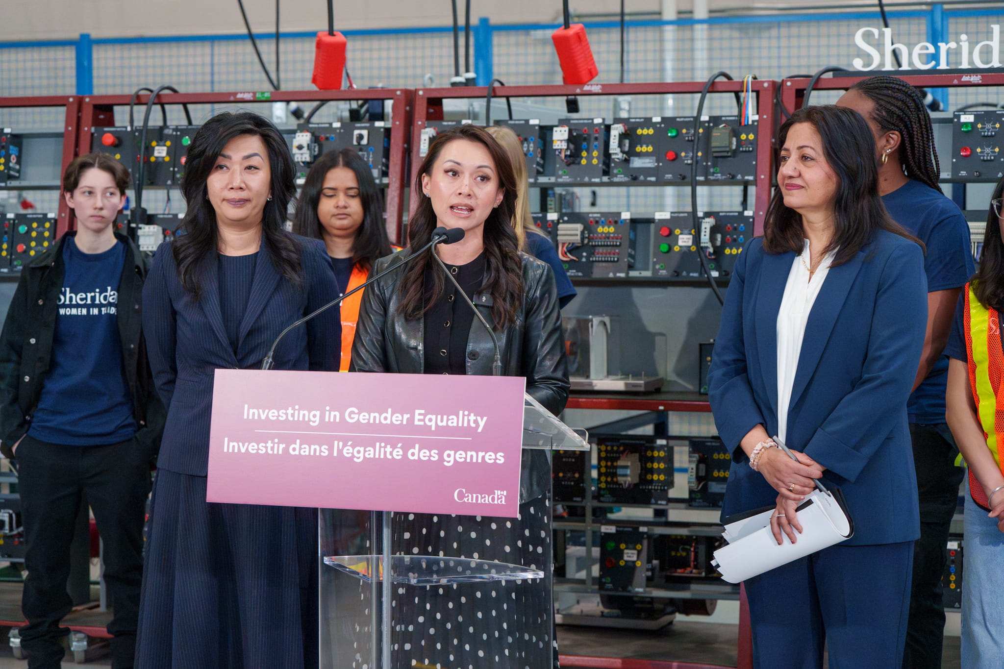 Department of Women and Gender Equality (WAGE) Minister Rechie Valdez speaks at the podium during an announcement at Magna Skilled Trades Centre.
