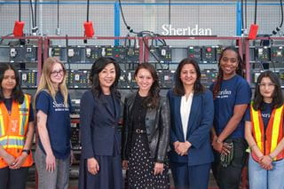 Sheridan President and Vice Chancellor Dr. Cindy Gouveia, federal Minister Rechie Valdez and MP Sonia Sidhu gather for a photo with students inside Magna Skilled Trades Centre