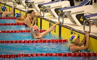 Thumbs up female swimmer