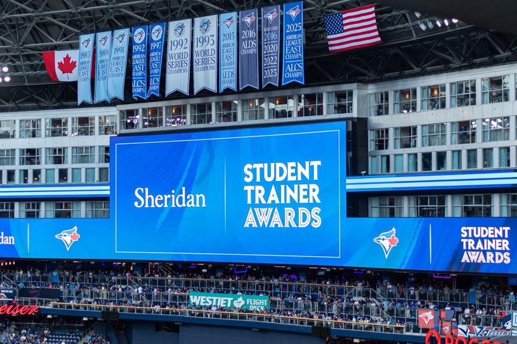 An announcement about the student trainer awards featuring Sheridan's logo on the Jumbotron at the Rogers Centre