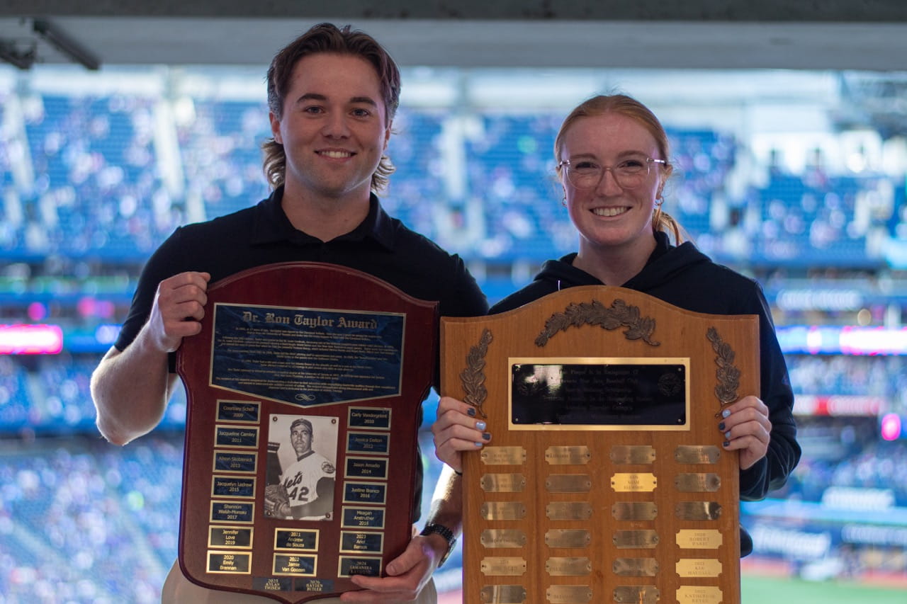 Sheridan Athletic Therapy students and Blue Jays award recipients Hayden Butler-Benn and Payton Barkley pose for a photo holding up their plaques