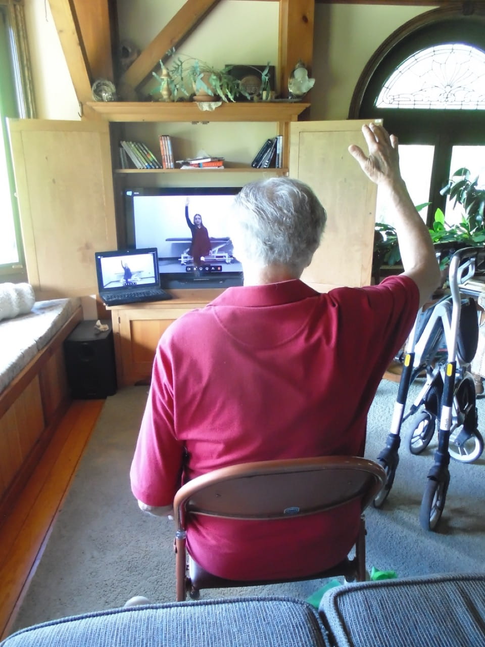Movement Matters client John Wilson faces a screen where a Sheridan student therapist leads him through his exercises