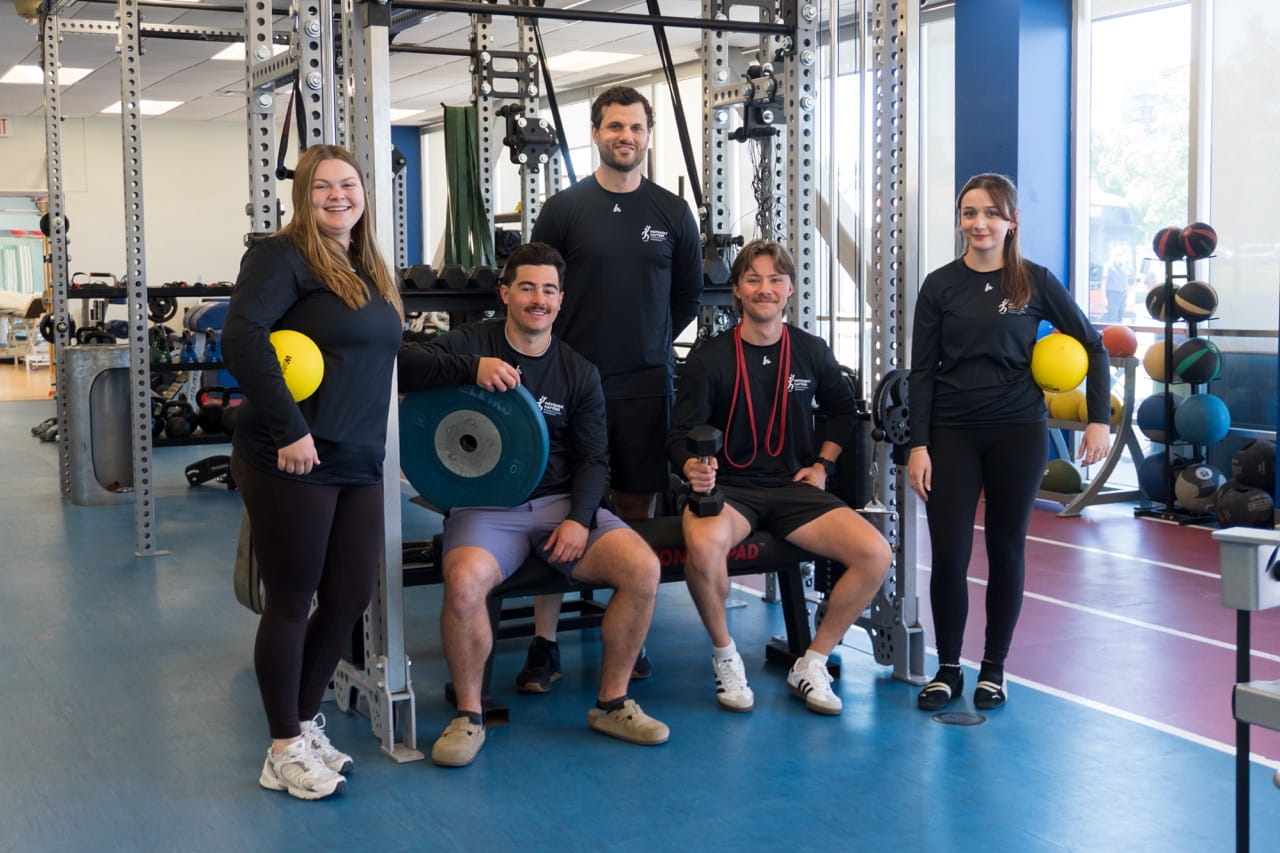 Staff and student therapists from Sheridan's Movement Matters clinic are pictured in a gym environment