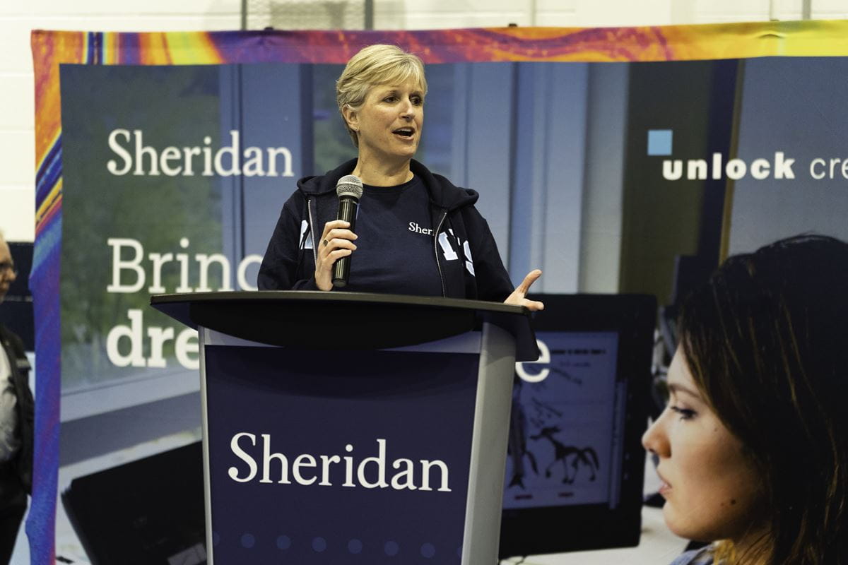Provost Mary Vaughan speaks at a podium that says Sheridan.