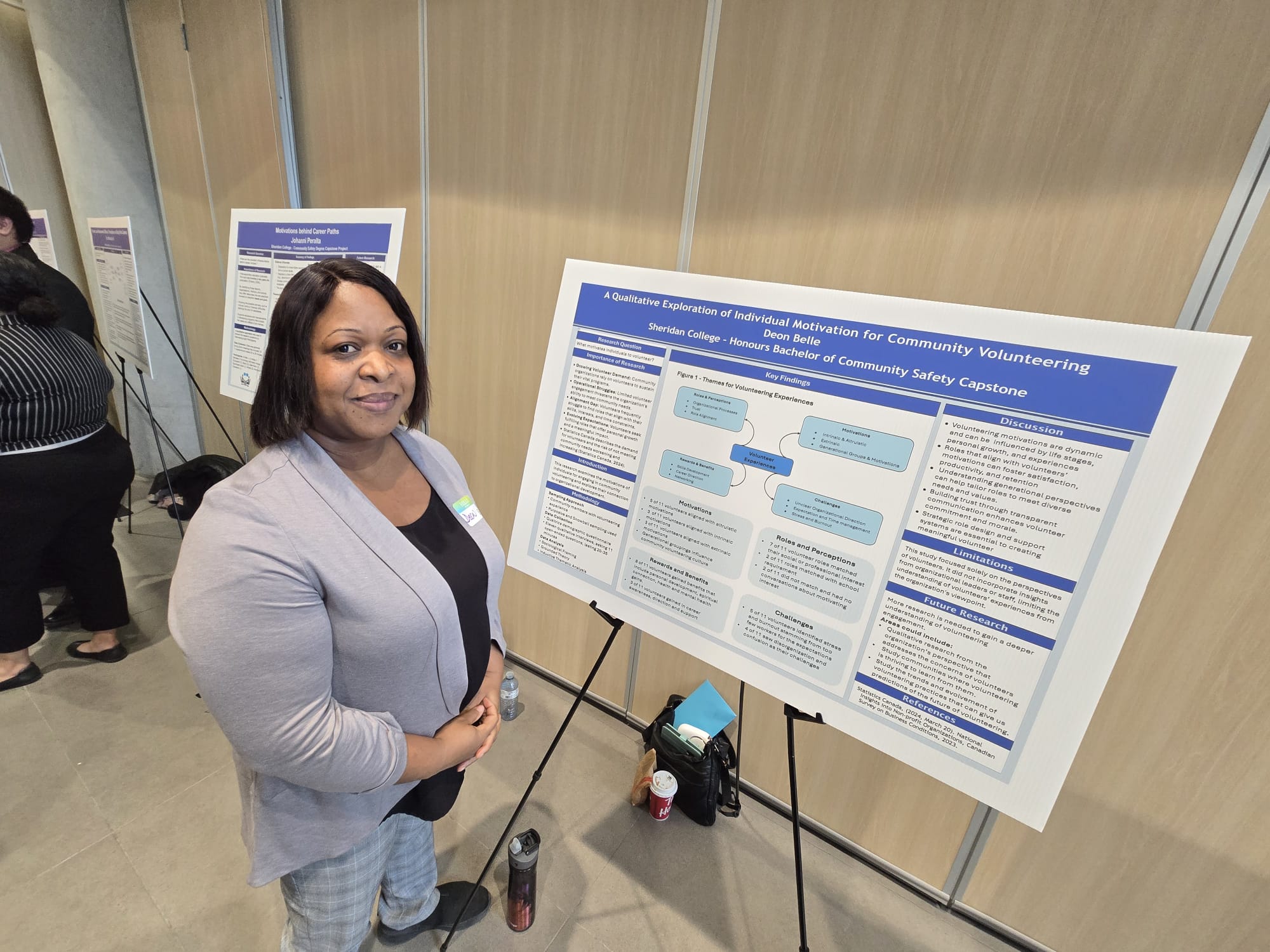 Student Deon Belle is pictured with the poster for her capstone project A Qualitative Exploration of Individual Motivations to Community Volunteering