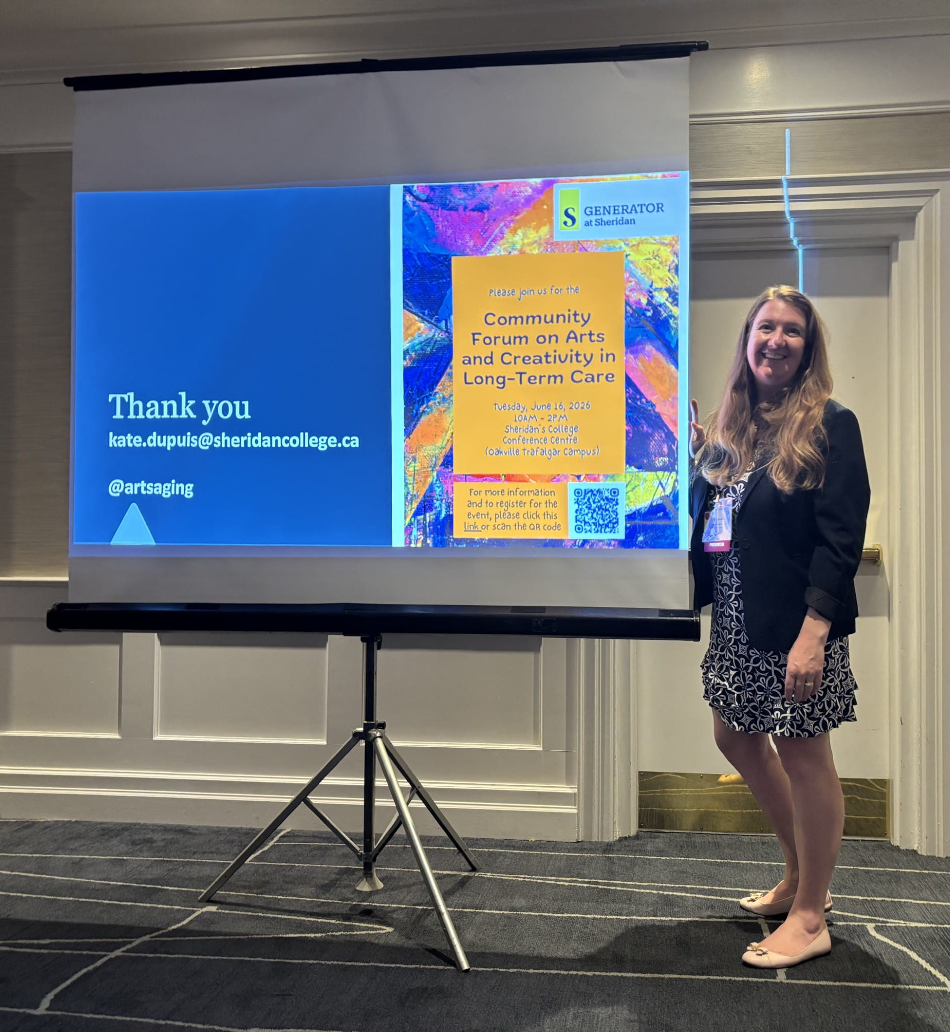 CER researcher and Schlegel Innovation Leader in Arts and Aging Dr. Kate Dupuis stands beside a graphic promoting a Community Forum on Arts and Creativity in Long-Term Care