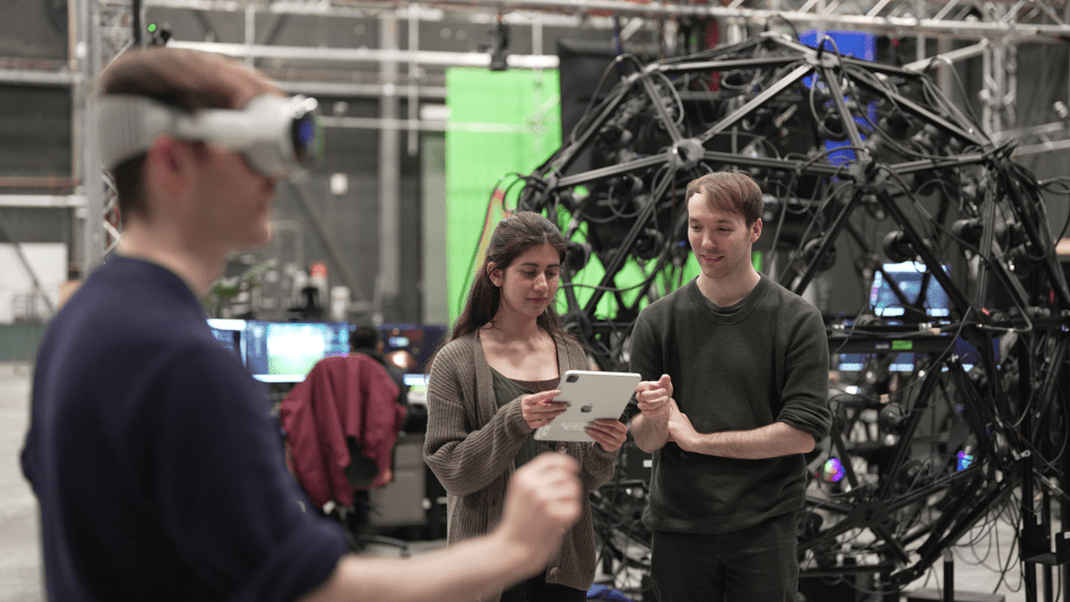 Twin brothers Patrick and Thomas Morris work on a research project with fellow co-op student Shehnazdeep Kaur inside the Screen Industries Research Training (SIRT) Centre.