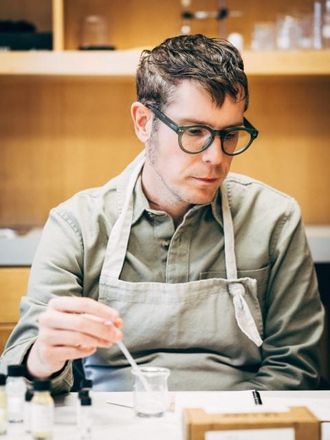 Sheridan professor Jamie March is seated at a table working on a project