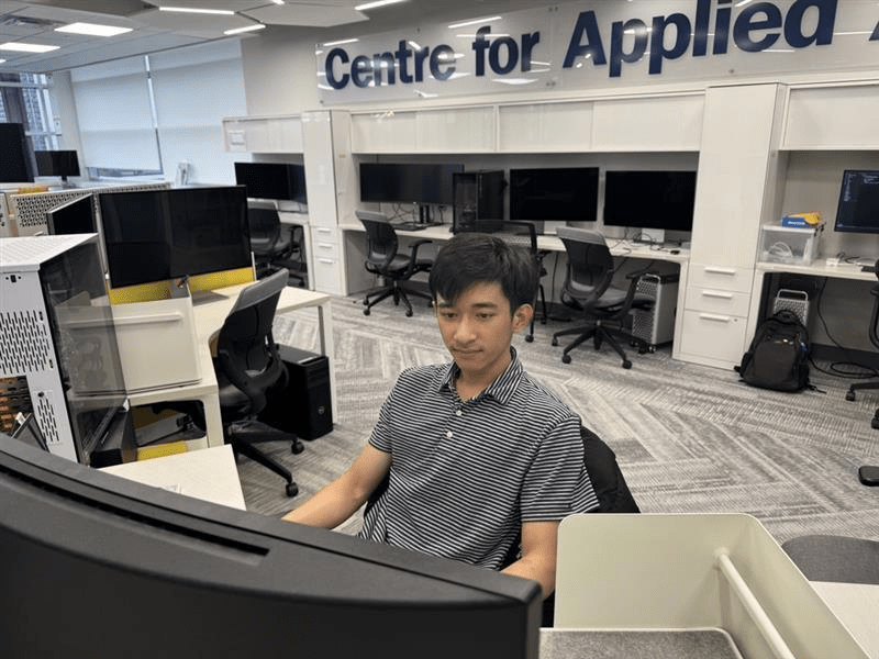 Sheridan student Hoang Duy Ho is pictured working at a computer inside the Centre for Applied AI